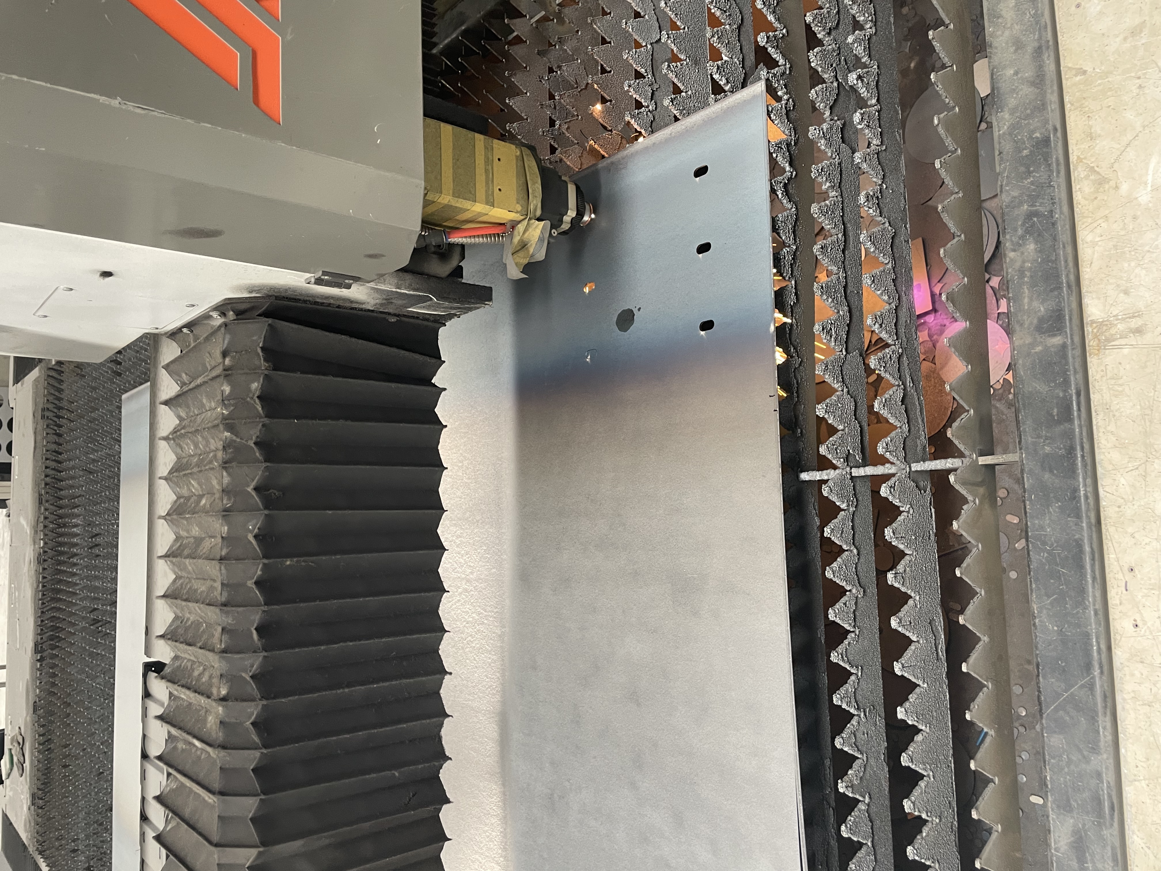 Close view of laser cutting holes in dust collector steel plate